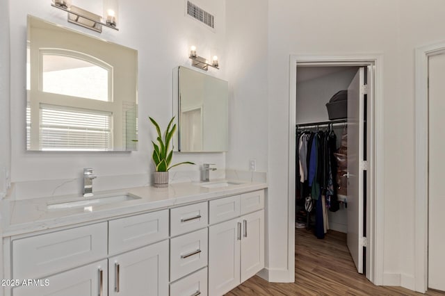 821 E Chicago St, Chandler, AZ 85225 - bathroom featuring a sink, wood finished floors, double vanity, and visible vents
