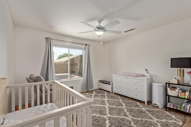 821 E Chicago St, Chandler, AZ 85225 - bedroom with a nursery area, a ceiling fan, wood finished floors, and visible vents