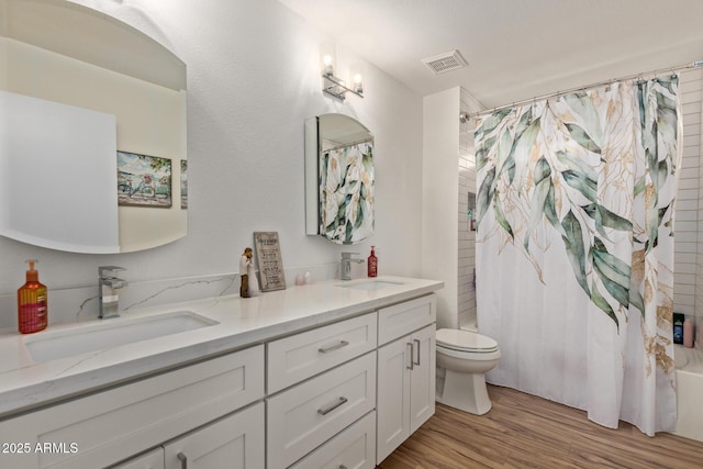 821 E Chicago St, Chandler, AZ 85225 - full bathroom featuring a sink, double vanity, toilet, shower / bath combo with shower curtain, and wood finished floors