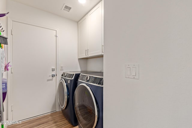 821 E Chicago St, Chandler, AZ 85225 - washroom with cabinet space, light wood-style floors, visible vents, and washing machine and clothes dryer