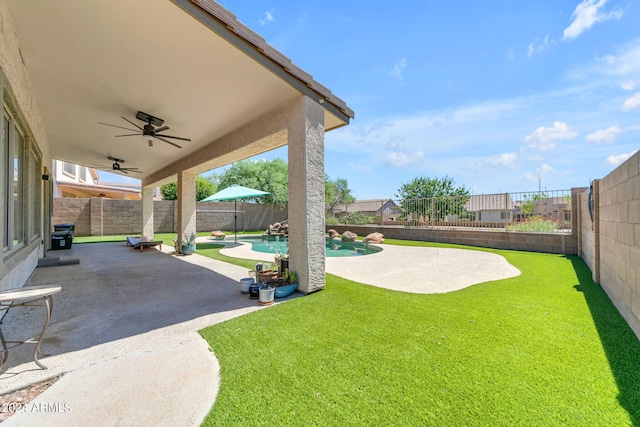 view of yard featuring a fenced in pool, a patio, and ceiling fan