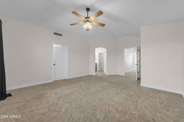 empty room featuring ceiling fan and light colored carpet