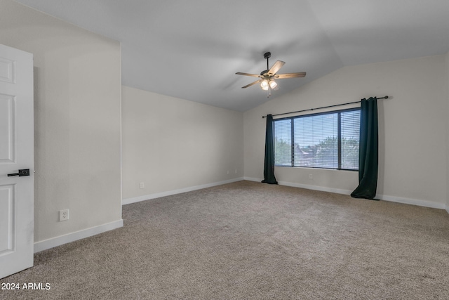 carpeted empty room featuring lofted ceiling and ceiling fan