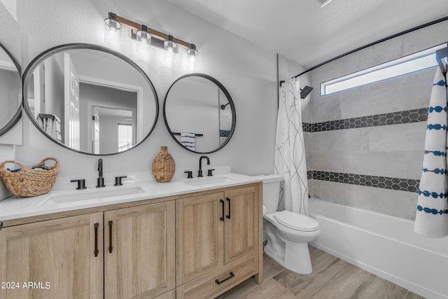 full bathroom featuring hardwood / wood-style flooring, vanity, toilet, and shower / bath combo with shower curtain