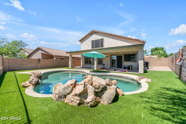 view of swimming pool featuring a patio and a lawn