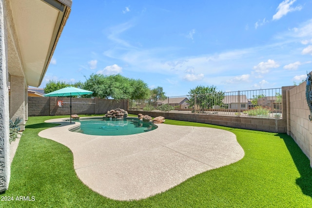 view of swimming pool featuring a yard and a patio area