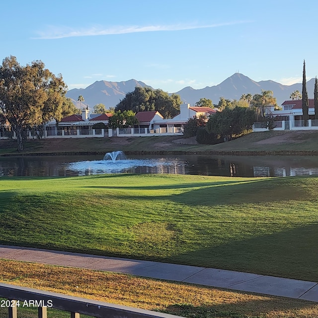 view of home's community with a yard and a water and mountain view