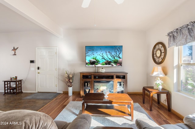 living room featuring ceiling fan, beamed ceiling, and dark wood-type flooring