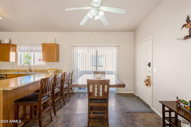 dining room featuring ceiling fan and sink