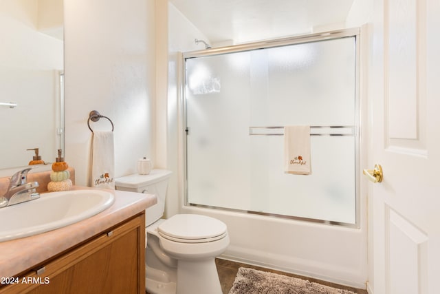 full bathroom with tile patterned floors, vanity, toilet, and enclosed tub / shower combo