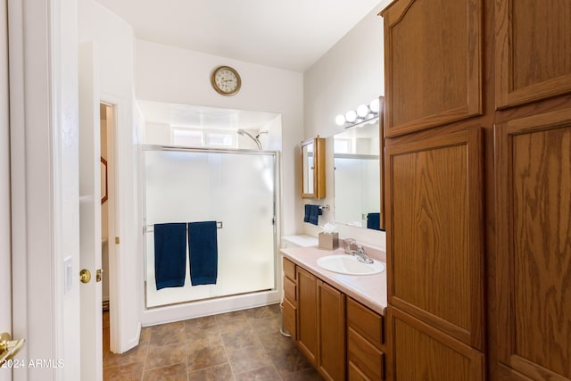 bathroom with vanity and an enclosed shower