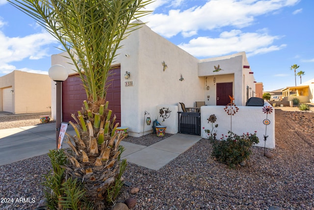 pueblo-style home featuring a garage