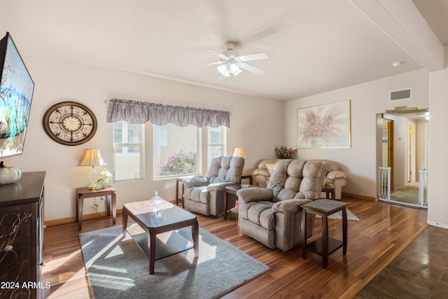 living room featuring beamed ceiling, hardwood / wood-style floors, and ceiling fan