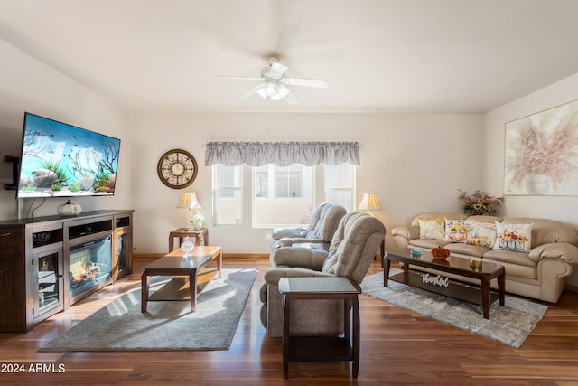 living room featuring ceiling fan and dark hardwood / wood-style flooring