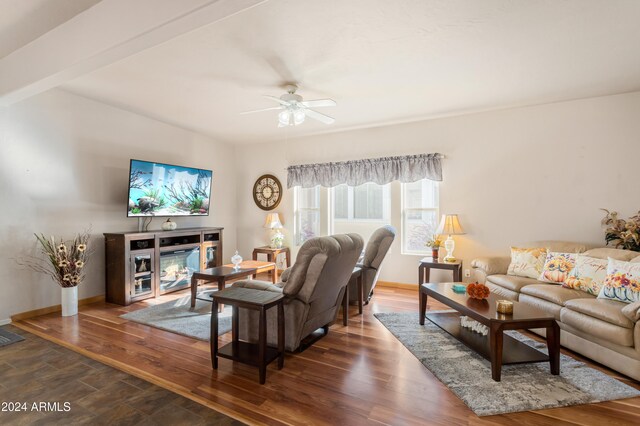 living room with ceiling fan and dark wood-type flooring