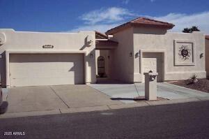 pueblo-style house featuring a garage