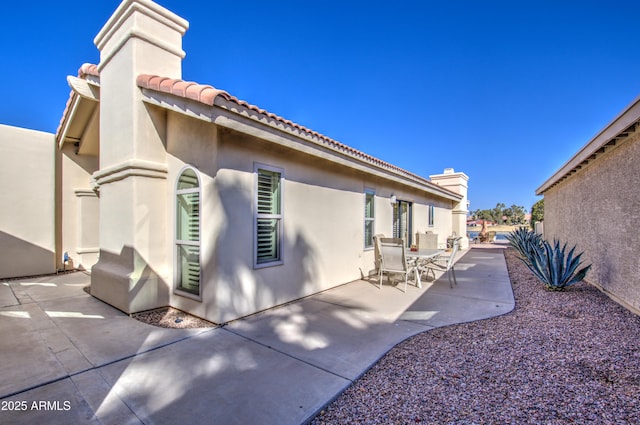 view of side of home featuring a patio area