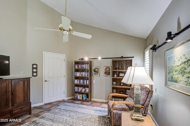 living area featuring lofted ceiling, tile patterned floors, and ceiling fan