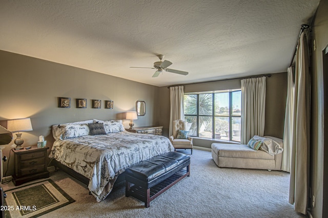 carpeted bedroom featuring a textured ceiling and ceiling fan