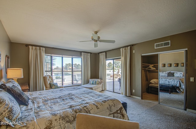 bedroom featuring ceiling fan, carpet flooring, a textured ceiling, access to outside, and a closet