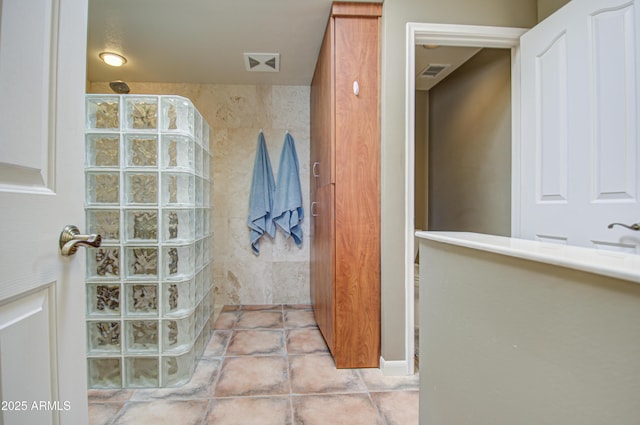 bathroom featuring tile patterned floors and a shower