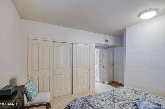 carpeted bedroom featuring a closet