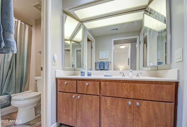 full bathroom with vanity, shower / bath combo with shower curtain, and toilet