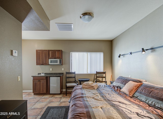 tiled bedroom featuring refrigerator