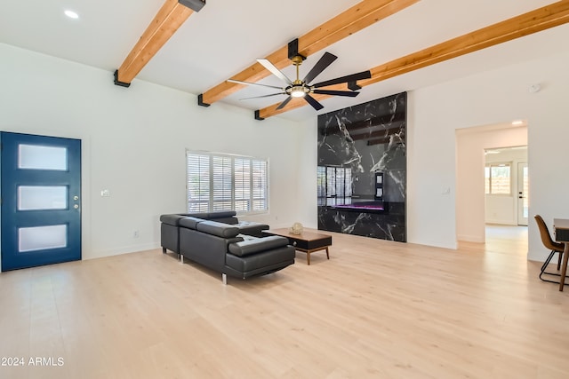 living room with beamed ceiling, ceiling fan, and hardwood / wood-style flooring