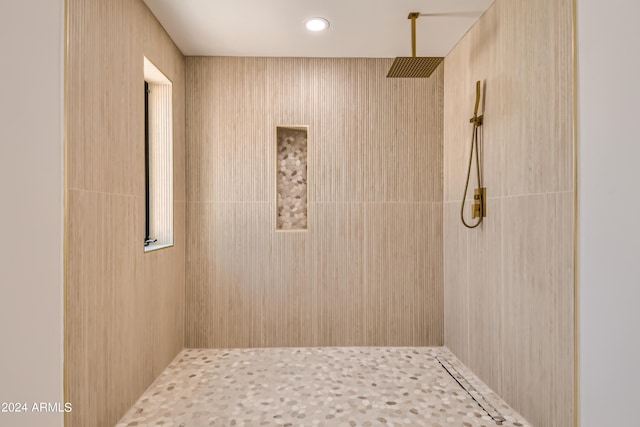 bathroom with tiled shower