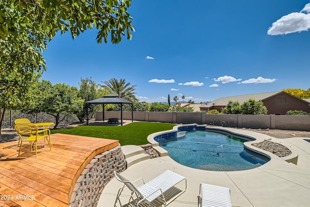 view of swimming pool featuring a deck, a gazebo, and a lawn