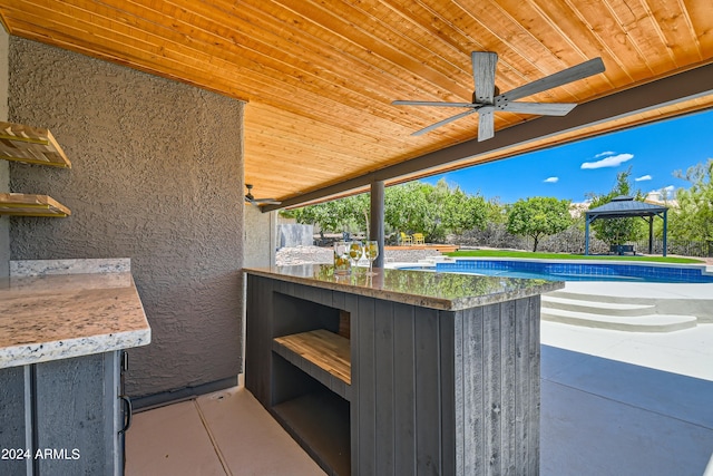 view of terrace featuring ceiling fan and a gazebo