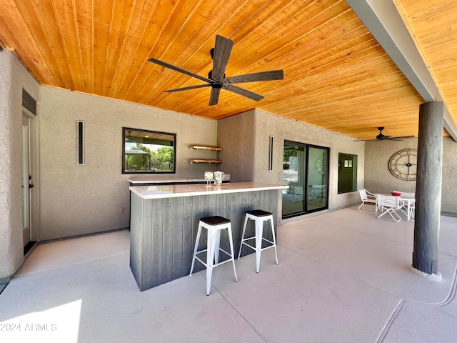 view of patio featuring an outdoor bar and ceiling fan