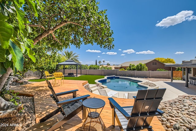 view of pool with a deck and a gazebo