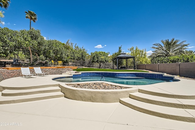 view of swimming pool featuring a patio, a hot tub, pool water feature, and a gazebo