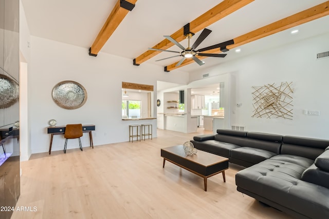 living room with light hardwood / wood-style flooring, beamed ceiling, and ceiling fan