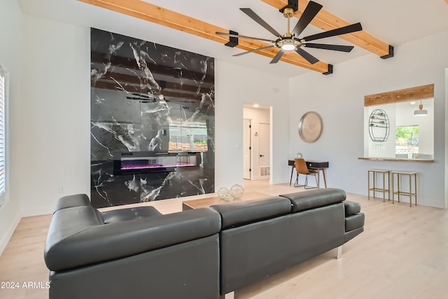 living room with hardwood / wood-style flooring, beam ceiling, and ceiling fan