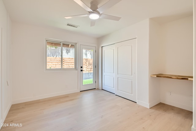 unfurnished bedroom featuring a closet, ceiling fan, light wood-type flooring, and access to outside