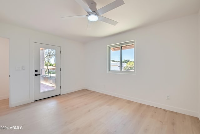 spare room with light hardwood / wood-style flooring and ceiling fan