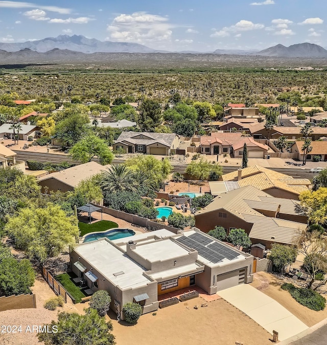 birds eye view of property with a mountain view