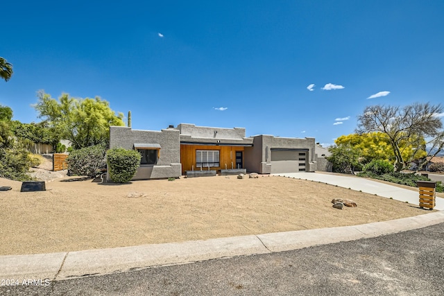 pueblo-style home featuring a garage