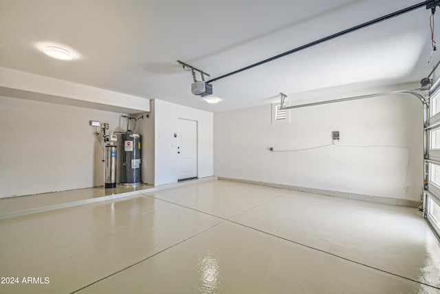 garage featuring a garage door opener and electric water heater