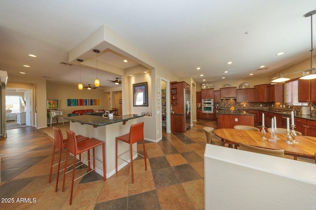 kitchen featuring pendant lighting, a kitchen island, and backsplash