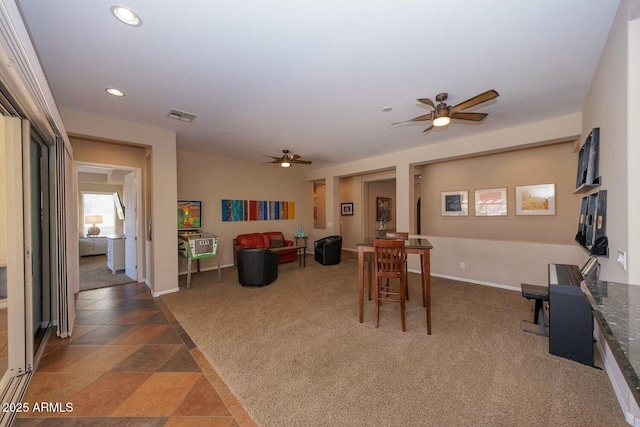 dining area with ceiling fan and carpet flooring