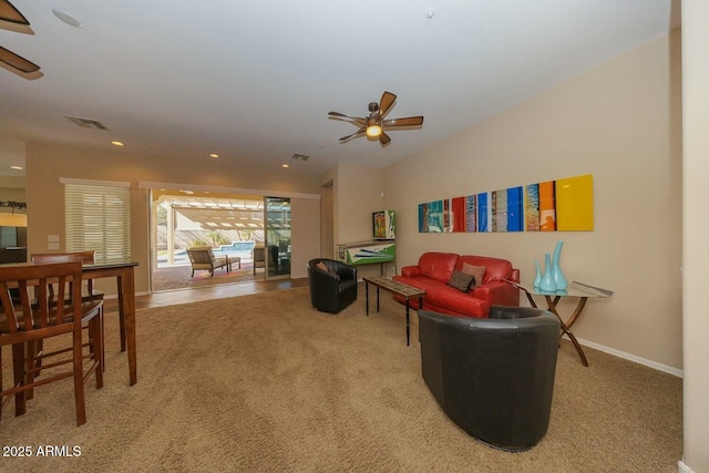 carpeted living room with ceiling fan