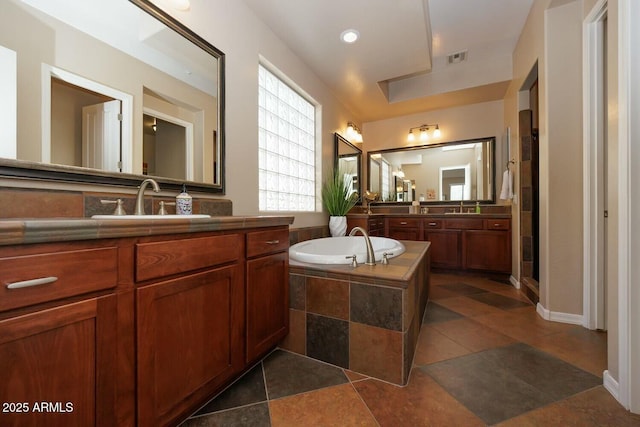 bathroom featuring tile patterned flooring, vanity, and independent shower and bath