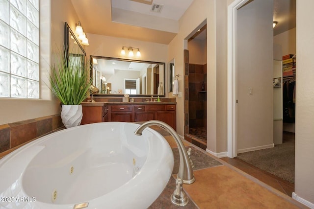 bathroom featuring vanity, tile patterned flooring, and shower with separate bathtub