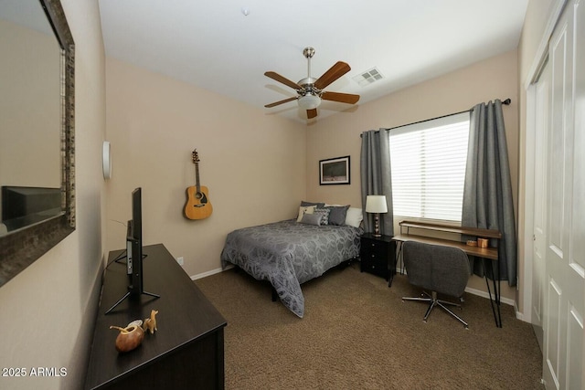 bedroom featuring dark colored carpet, ceiling fan, and a closet