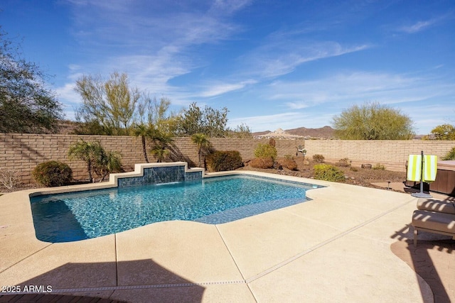 view of swimming pool with a patio and pool water feature