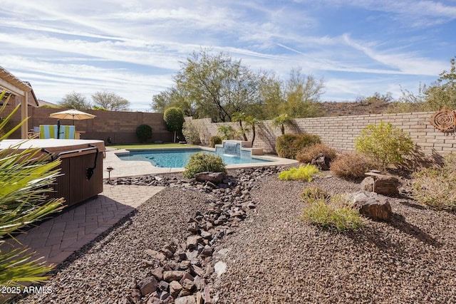 view of pool featuring a hot tub, a patio, and pool water feature